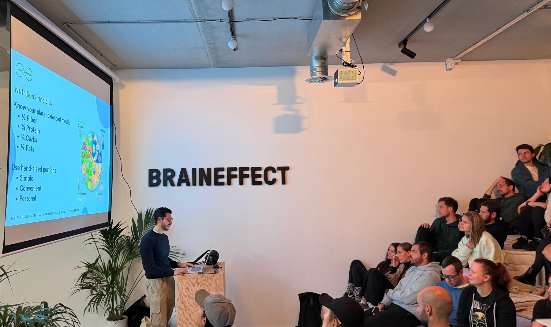 Angelo presenting a nutrition workshop to a seated audience